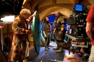 Peter Jackson talks to Graham McTavish while Martin Freeman, dressed as Bilbo Baggins, looks on.
